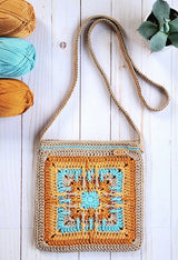 flat lay of multi color granny square crochet bag with yarn in top corner thumbnail