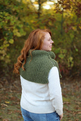 Back view of woman in white shirt and green cowl thumbnail