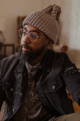 Man in tan hat looking sideways thumbnail