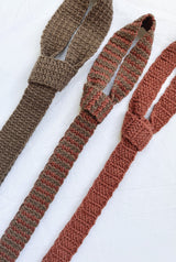 Three crochet ties, looped at the top, laid on a white background. thumbnail