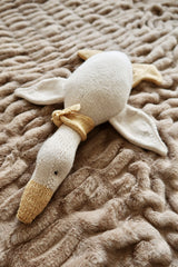Front view of knit stuffed goose on plush brown blanket. thumbnail