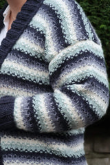 Close up of shoulder on cardigan, showing drop shoulder sleeve and navy ribbed neckband. thumbnail