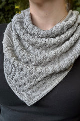 Close up of bandana style cabled cowl, showing pointed edge. thumbnail