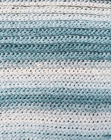 Extreme close-up of crochet wrap, showing ombre fade effect. thumbnail