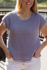 Cropped close up of crochet top, showing textured, slightly open stitch pattern. thumbnail