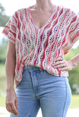 Cropped view of crochet top, partially tucked into jeans at the waist. thumbnail