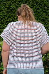 Back view of crochet top, showing drop shoulder construction and short sleeves. thumbnail