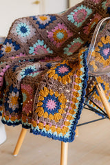 Close up of blanket border and corner square, showing floral granny square motif. thumbnail