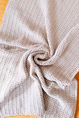 Top down view of crochet blanket swirled in the middle. thumbnail