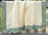 Full view of blanket draped over back of wooden bench. Blanket is shown in baby size. thumbnail