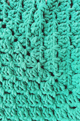 Close up of middle of crochet throw in green chenille yarn. thumbnail