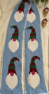 Close up of scarf with holiday gnome faces, with a tall striped hat, round nose, and long white beard. thumbnail
