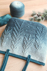 Close up of tote bag showing pine tree stitch pattern on horizontal textured background. thumbnail
