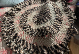 Top down view of circular crochet blanket. thumbnail