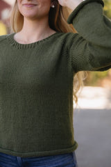 Cropped front view of knit sweater, showing small ribbed collar and stockinette body. thumbnail