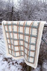 Plaid blanket hanging over fence. thumbnail