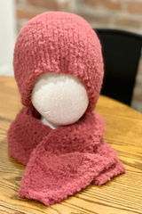 pink knit beanie and matching wrap scarf displayed together on a white foam mannequin head over a wooden surface thumbnail