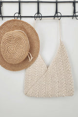 ecru bag hanging next to hat on rack thumbnail