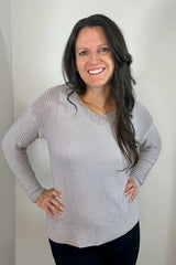 Woman wearing silver knit sweater thumbnail