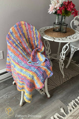 crocheted blanket made with pastel yarn with colorful shades thumbnail