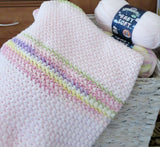 striped crochet blanket with yarn skeins in top corner thumbnail