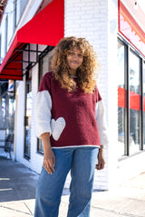 Woman wearing sweater with heart pocket thumbnail