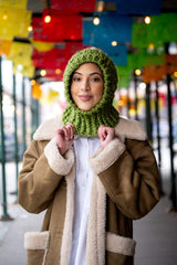 Woman in a granny square crochet hood thumbnail