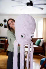 girl holding out oversized octopus thumbnail