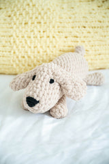 Crochet stuffed dog on a bed thumbnail