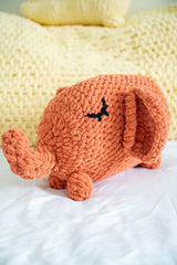 Stuffed elephant on a bed thumbnail