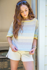 Model in doorway wearing a multicolor striped tee with mid length sleeves thumbnail