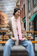 woman sitting down with knit scarf around her neck thumbnail