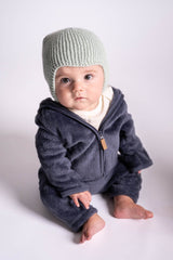 baby wearing knit hat in front of white background thumbnail