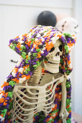 Crochet Halloween hooded blanket on a skeleton decoration thumbnail