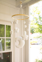 Crochet mobile hanging in front of a window thumbnail