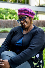 Woman wearing purple and pink striped beret thumbnail