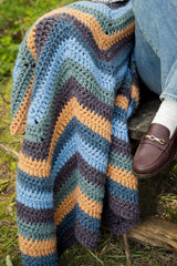closeup of a multicolor crochet blanket. thumbnail