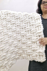 Woman holding cream colored crochet blanket thumbnail