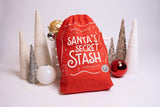 Santa's Secret Stash drawstring bag surrounded by Christmas decorations thumbnail