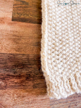 edge of whipped cream colored knitted blanket with seed stitch texture thumbnail