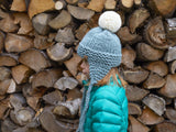 Knitted Ear Flap Hat Worn By A Child thumbnail