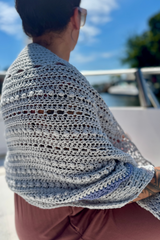 Gray and blue shawl draped over womans shoulders thumbnail