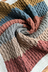 Close-up of striped crochet blanket with white border thumbnail