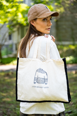 Woman in baseball cap with fair isle tote draped over her shoulder thumbnail