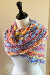 pastel virus stitch crochet shawl displayed on a mannequin with multicolor yarn thumbnail