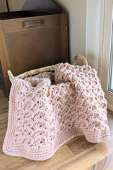 pink crochet blanket in basket thumbnail