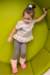 Little girl in knit top playing thumbnail