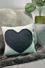 pillow with a heart and 4 buttons on a couch thumbnail