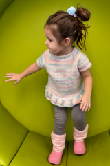 Little girl in knit top playing thumbnail