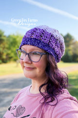 elixir beanie featuring purple ombre mandala yarn crocheted in a textured stitch pattern on model thumbnail